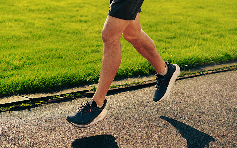 lower-body-of-a-runner-striding-on-outdoor-pavement